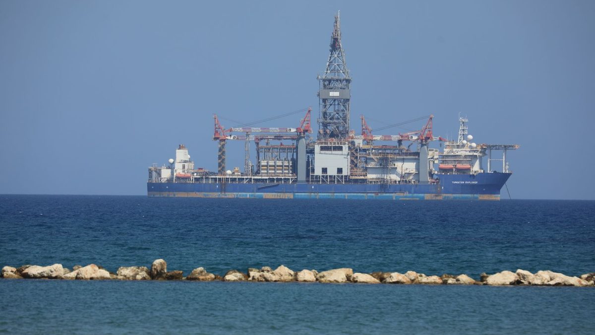 An offshore drilling rig on location, derrick and pipe handling equipment visible above the main deck